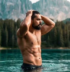 Bearded Man Standing in Mountain Lake